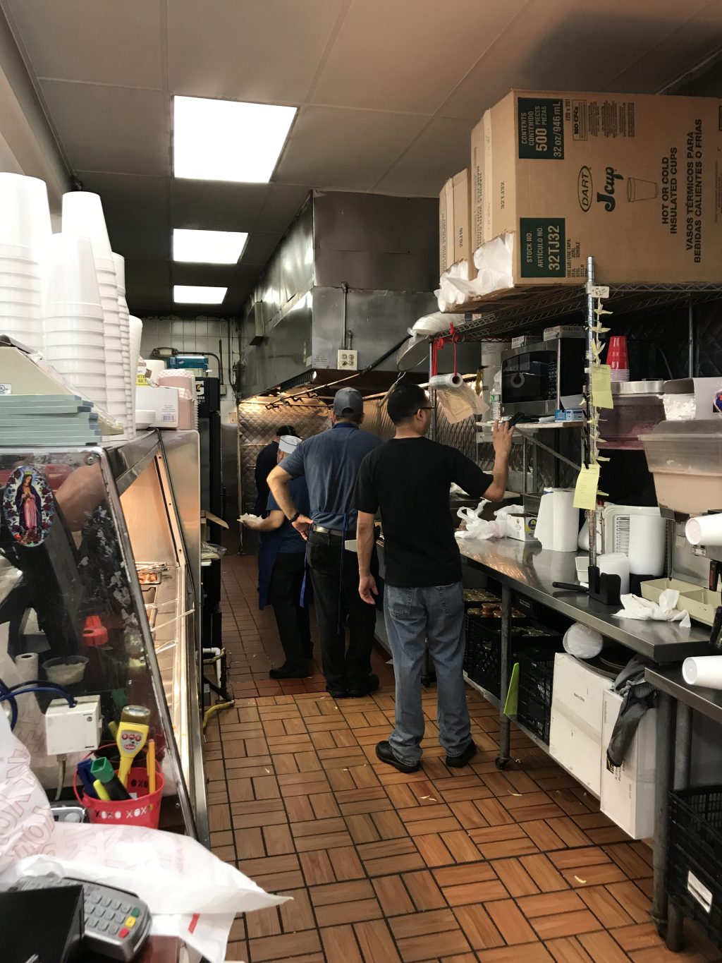 Workers in the kitchen in the back of Chapala's supermarket.