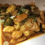 A close up of the seafood and rice cakes.
