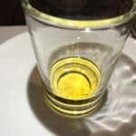 A small amount of Buffalo Trace bourbon in a glass.