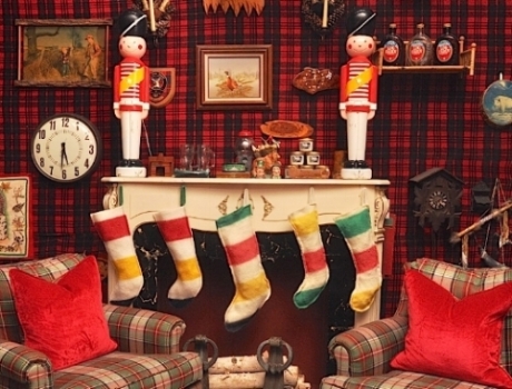 Five Christmas stockings over a fireplace.