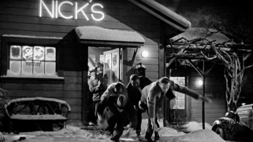 A frame from "It's a Wonderful Life" with characters leaving Nick's bar.