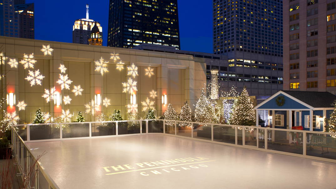 The Peninsula ice rink on a Chicago rooftop among the skyline.