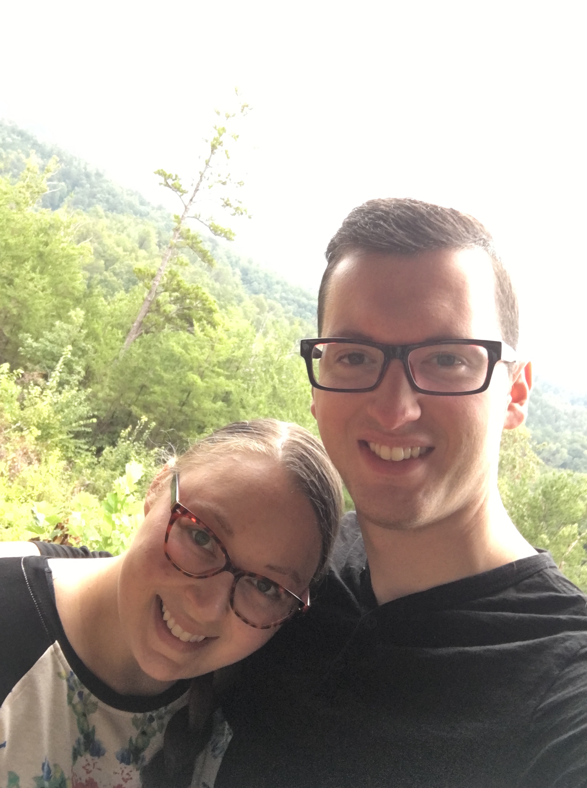 A selfie of "The Speedy Spatula" and her husband overlooking the top of a forest.