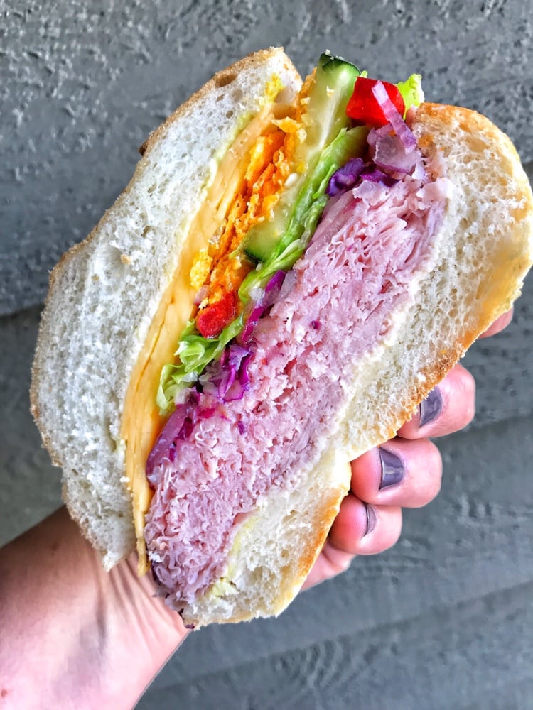 A close up of half of a sliced ham sandwich.