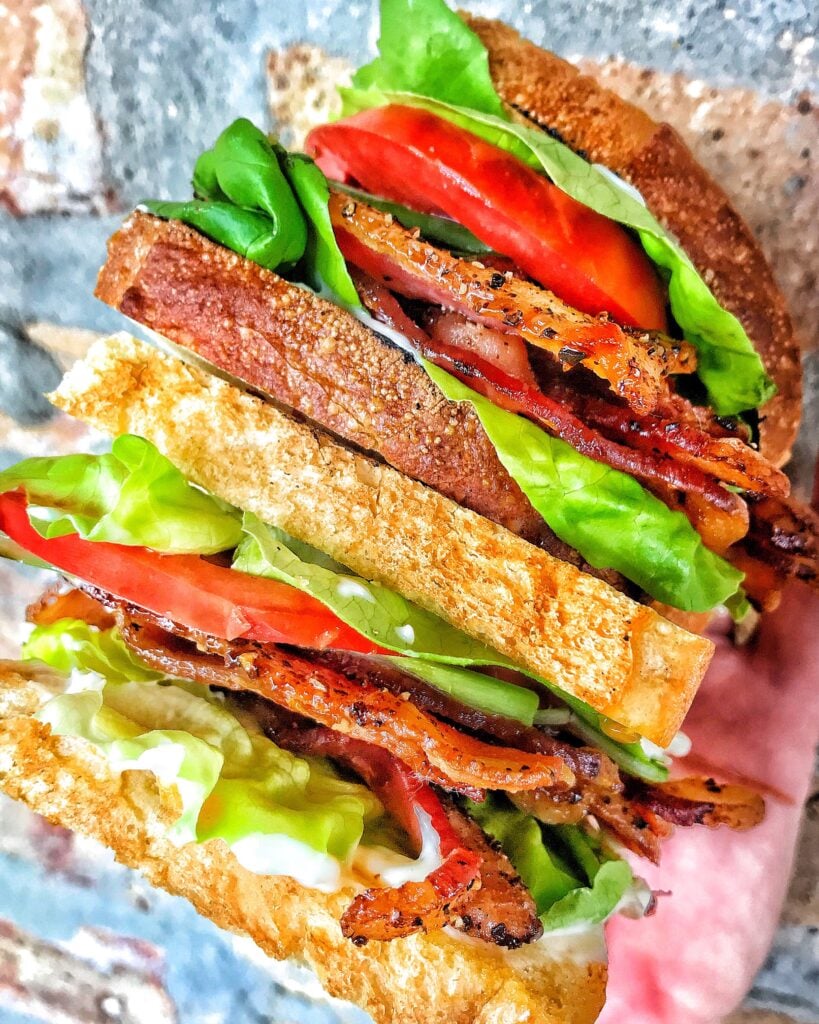 Two haves of a BLT sandwich.