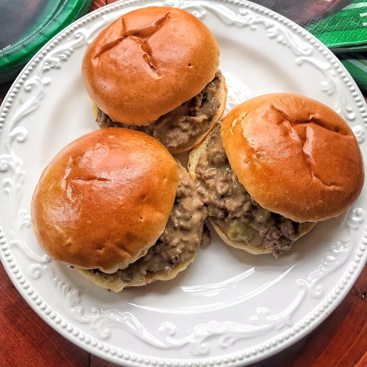 Three Philly Cheesesteak Sloppy Joes on a white plate.