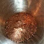 Chocolate cake mix in a metal bowl.
