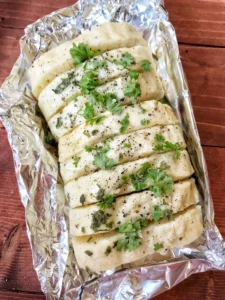 Sliced bread dumplings on foil with parsley. 
