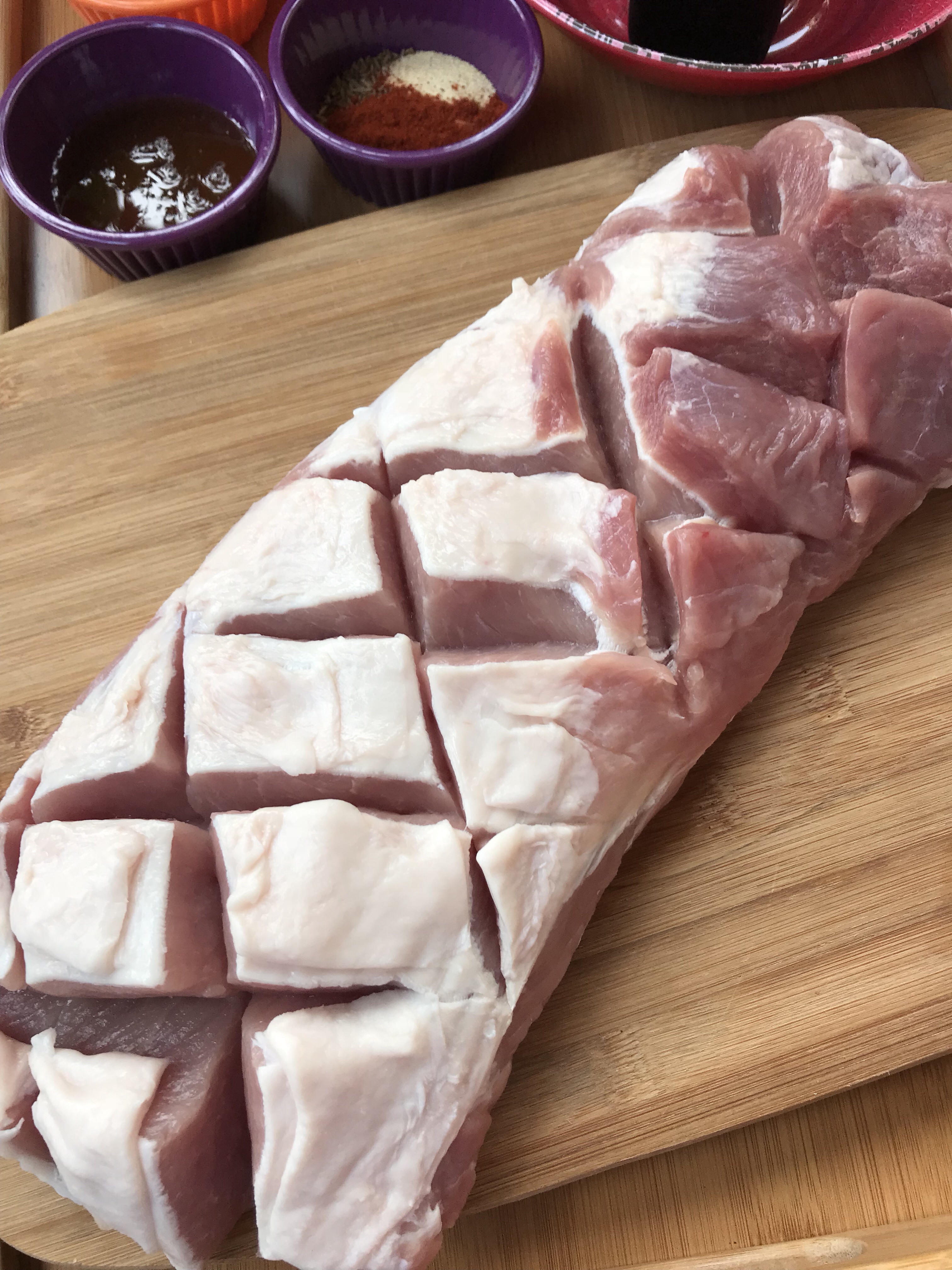A latticed raw pork tenderloin.