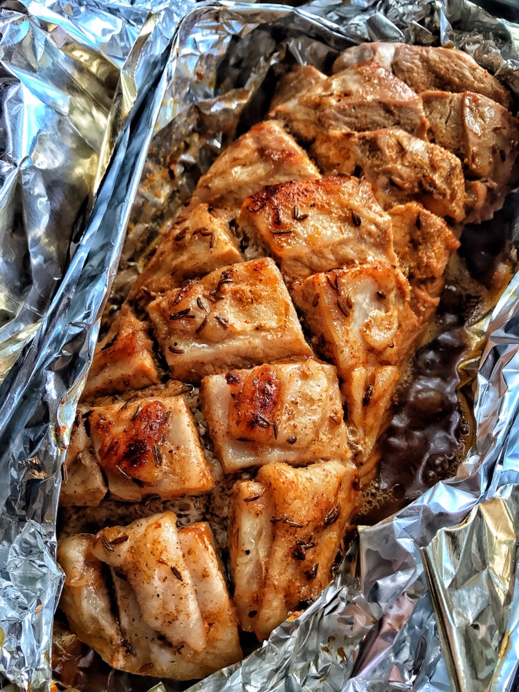 The cooked pork tenderloin in its foil pouch.