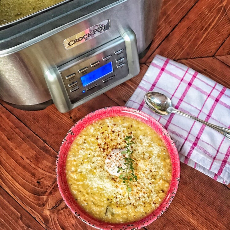 Crockpot Corn Chowder in a red bowl next to the Crockpot.