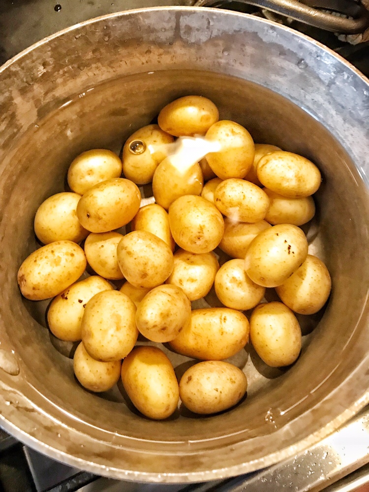 Potatoes boiling in a pot.