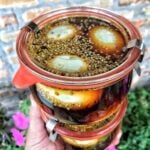 The sealed jar of marinated eggs.