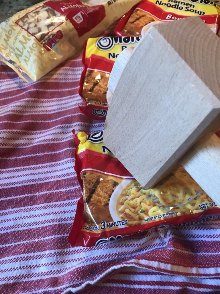 A mallet smashing the noodle packets