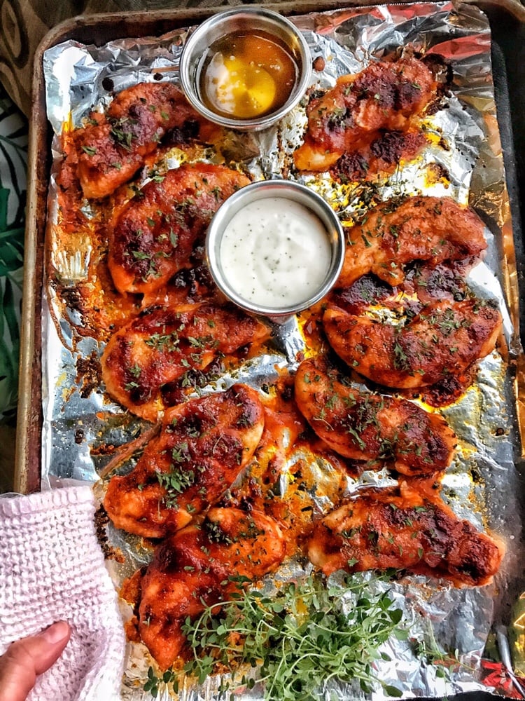 Buffalo Chicken Tender on a baking sheet with two dipping sauces.