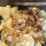 Onions and potatoes being mixed together