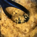 The filling for the squash being mashed