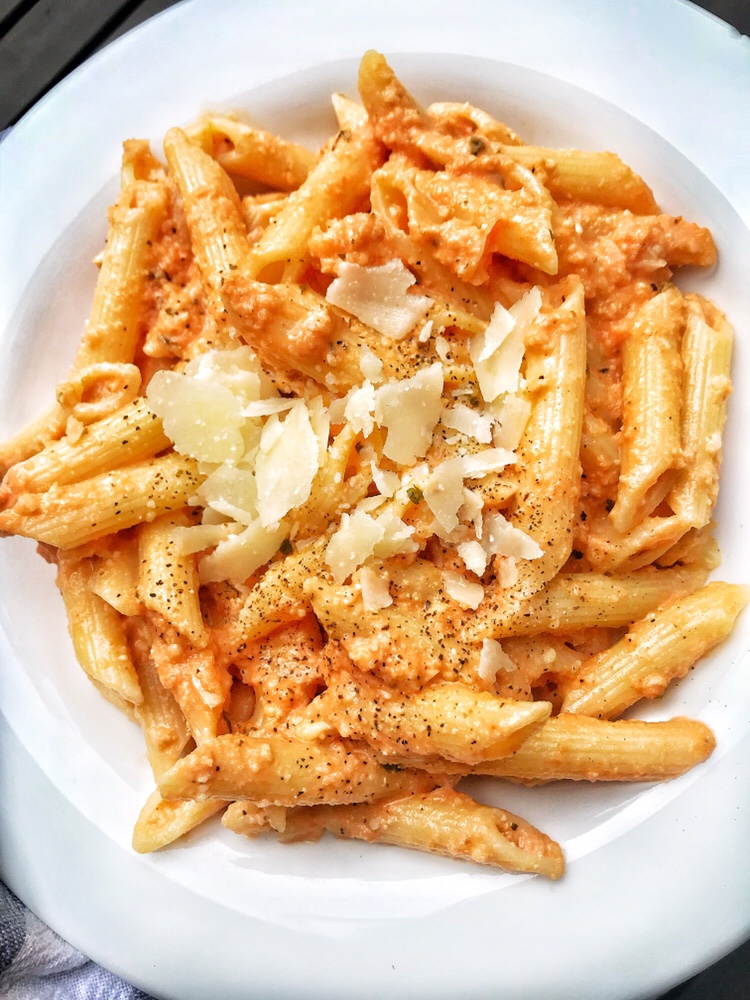 Pasta with vodka sauce topped with cheese