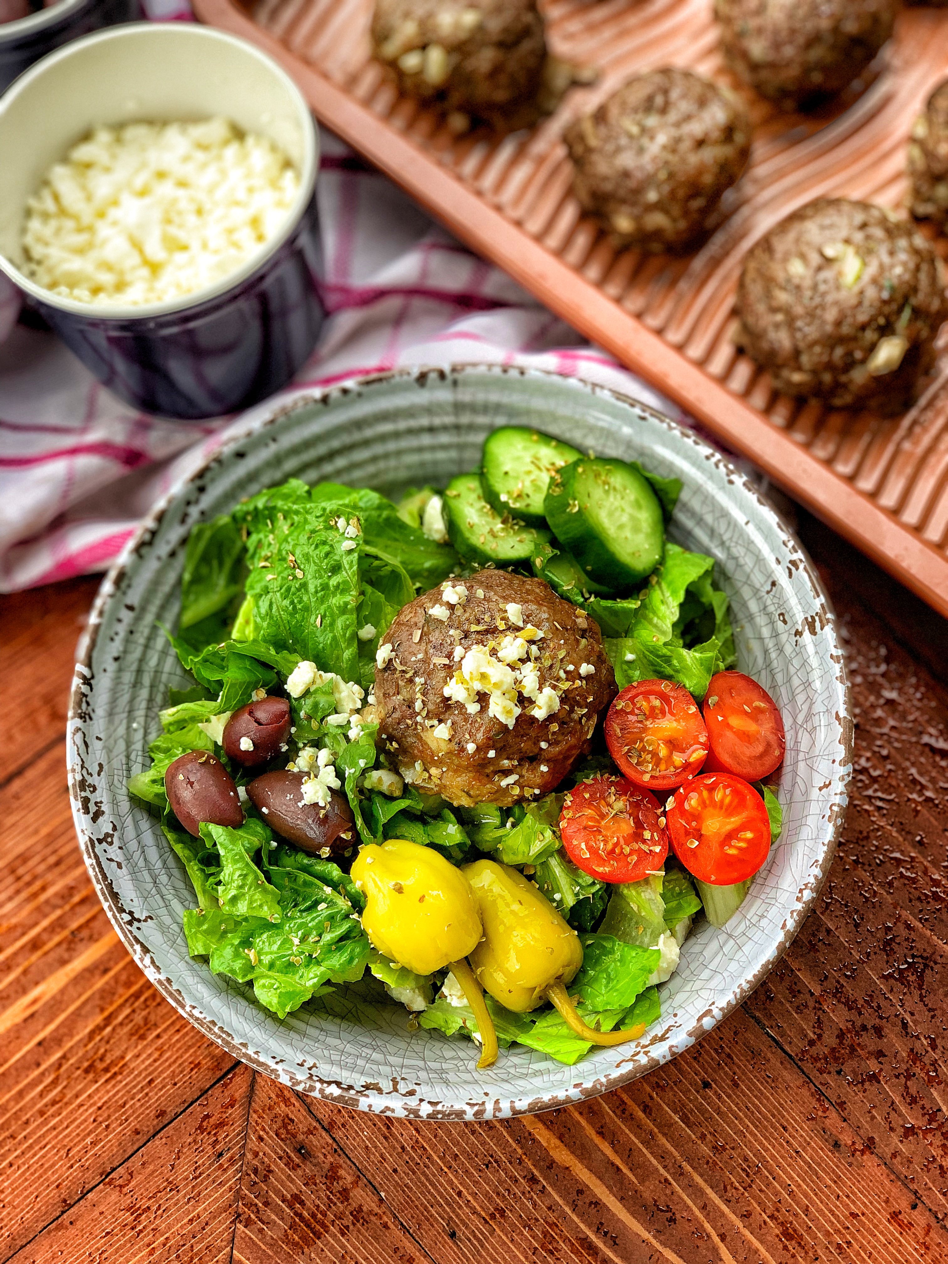 A Gyro meatball on top of salad