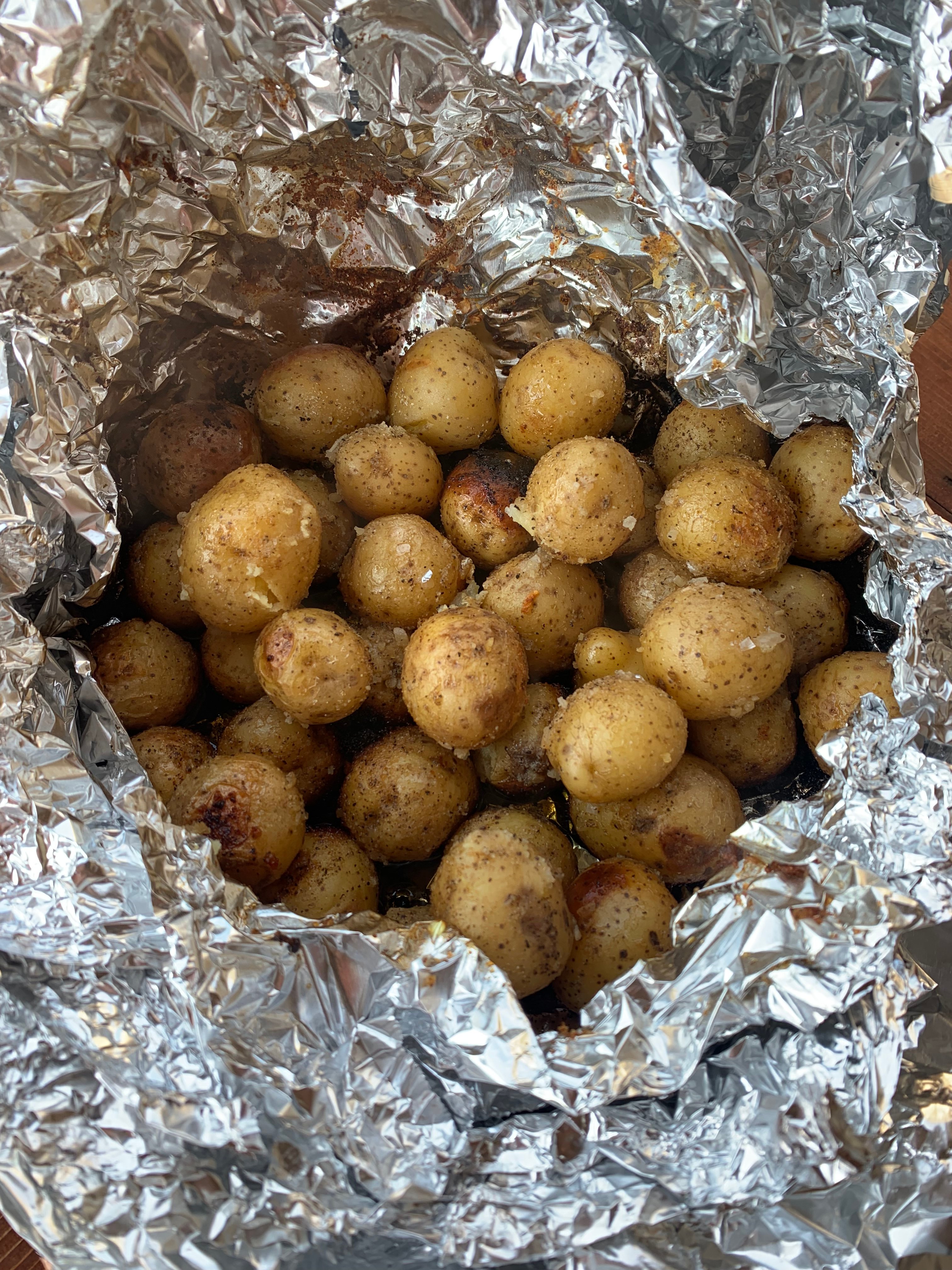 A bunch of baby potatoes in a tin foil bowl