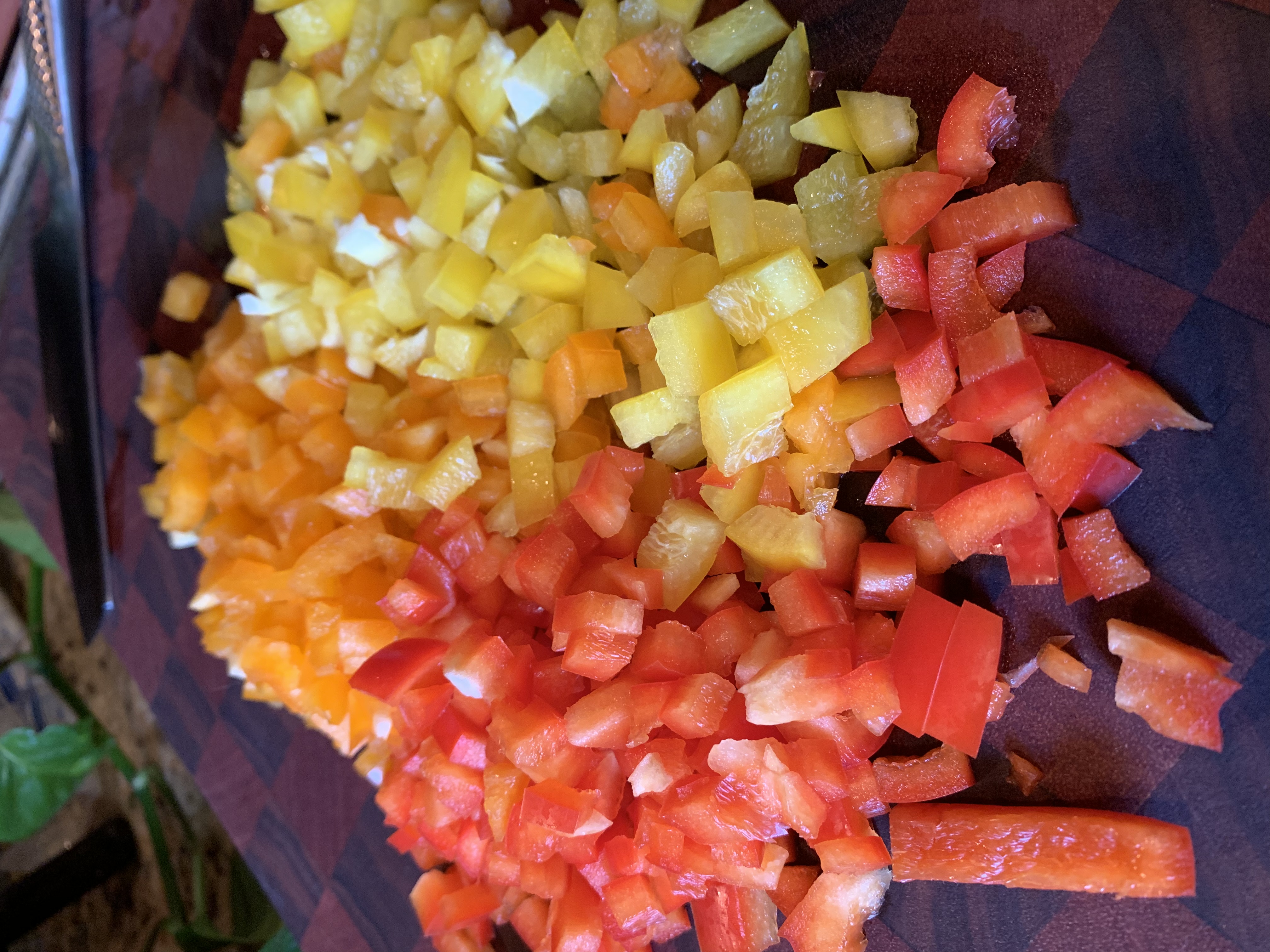 Picture of three colors of peppers diced small.