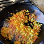 Diced peppers cooking in a pan