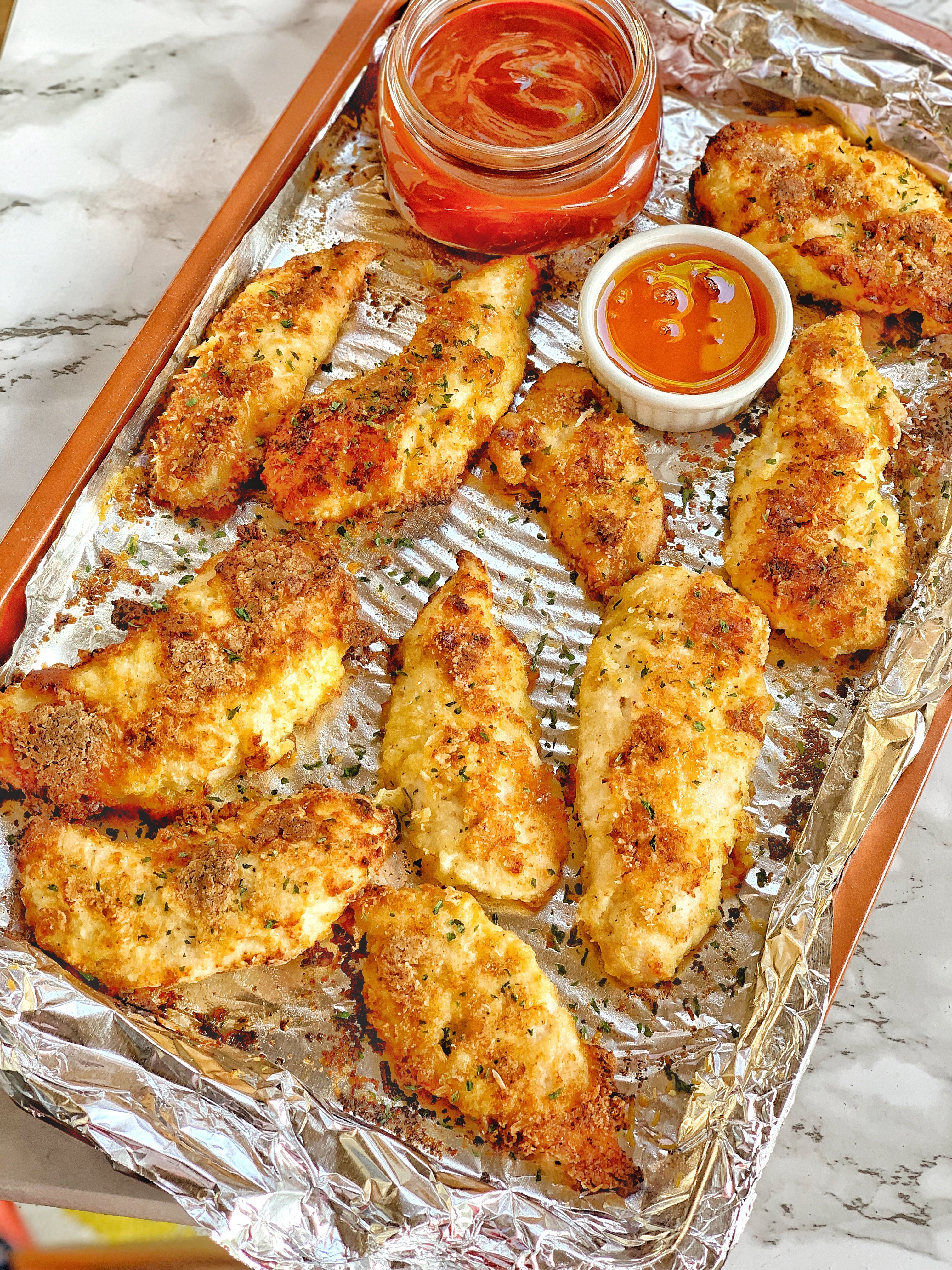 Parmesan baked chicken tenders with two sauces.