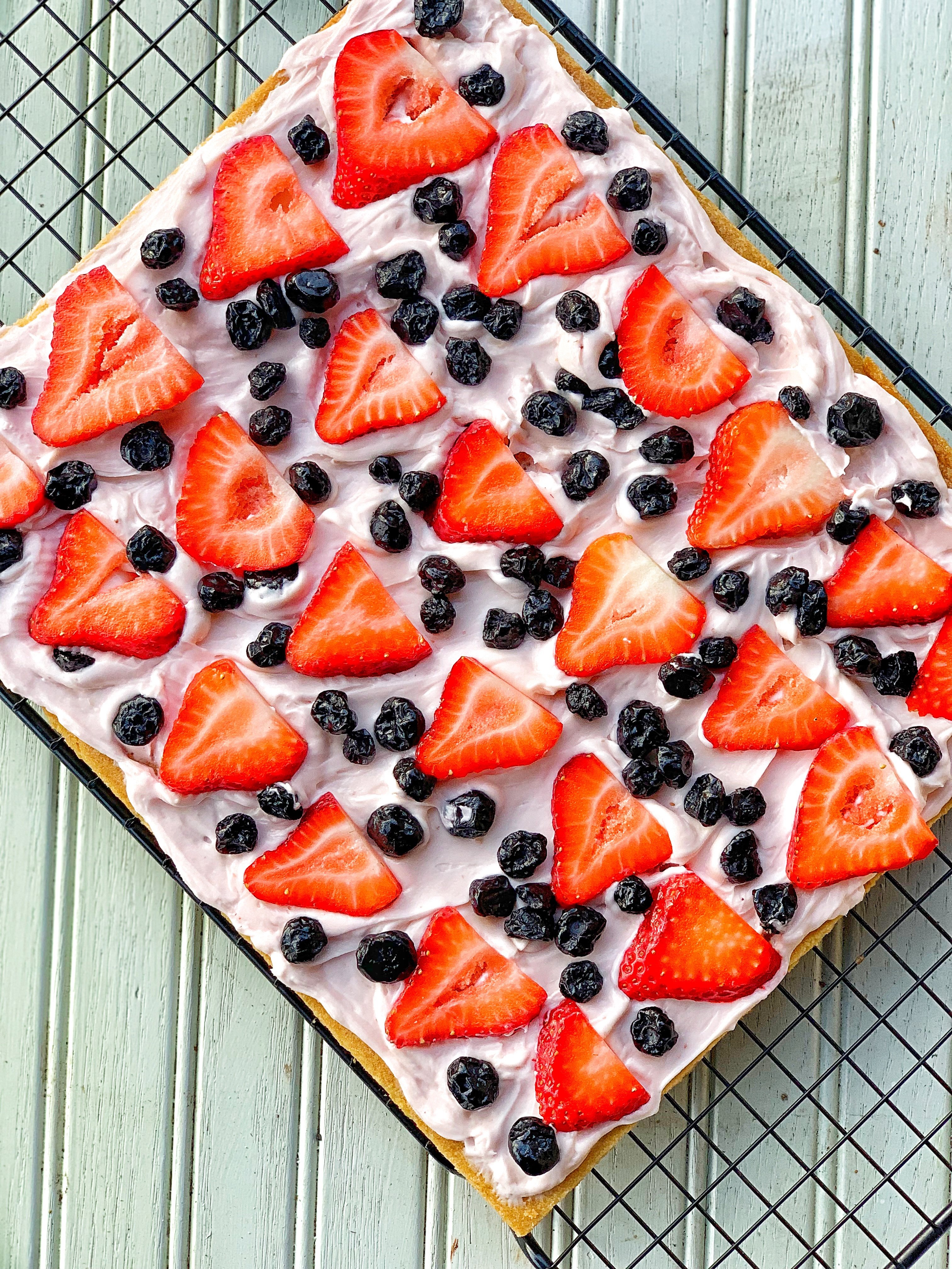 Picture of a cookie crust with cream cheese, strawberries, blue berries AKA Fruit Pizza