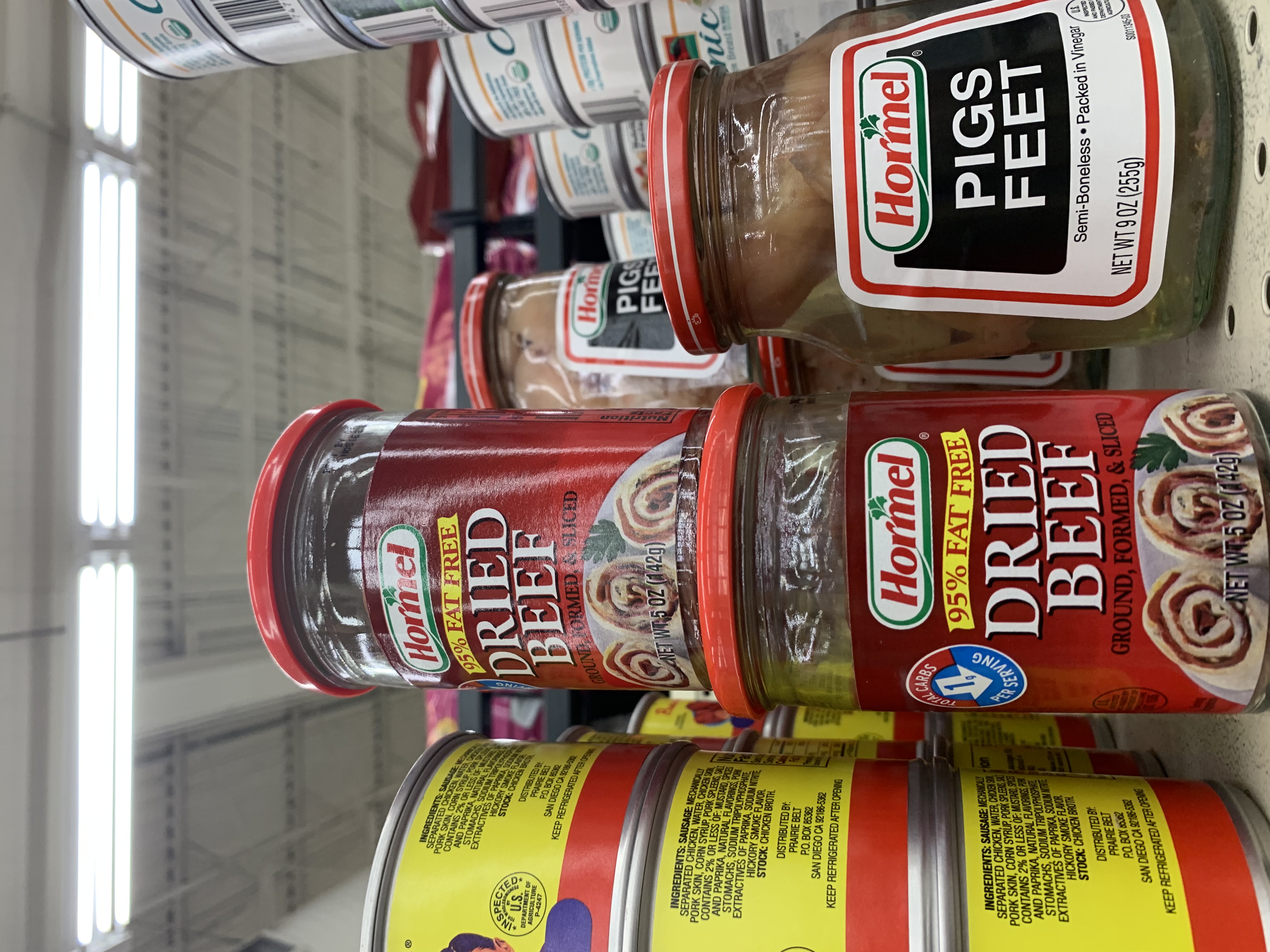 Jars of Hormel dried beef and pigs feet on a supermarket shelf