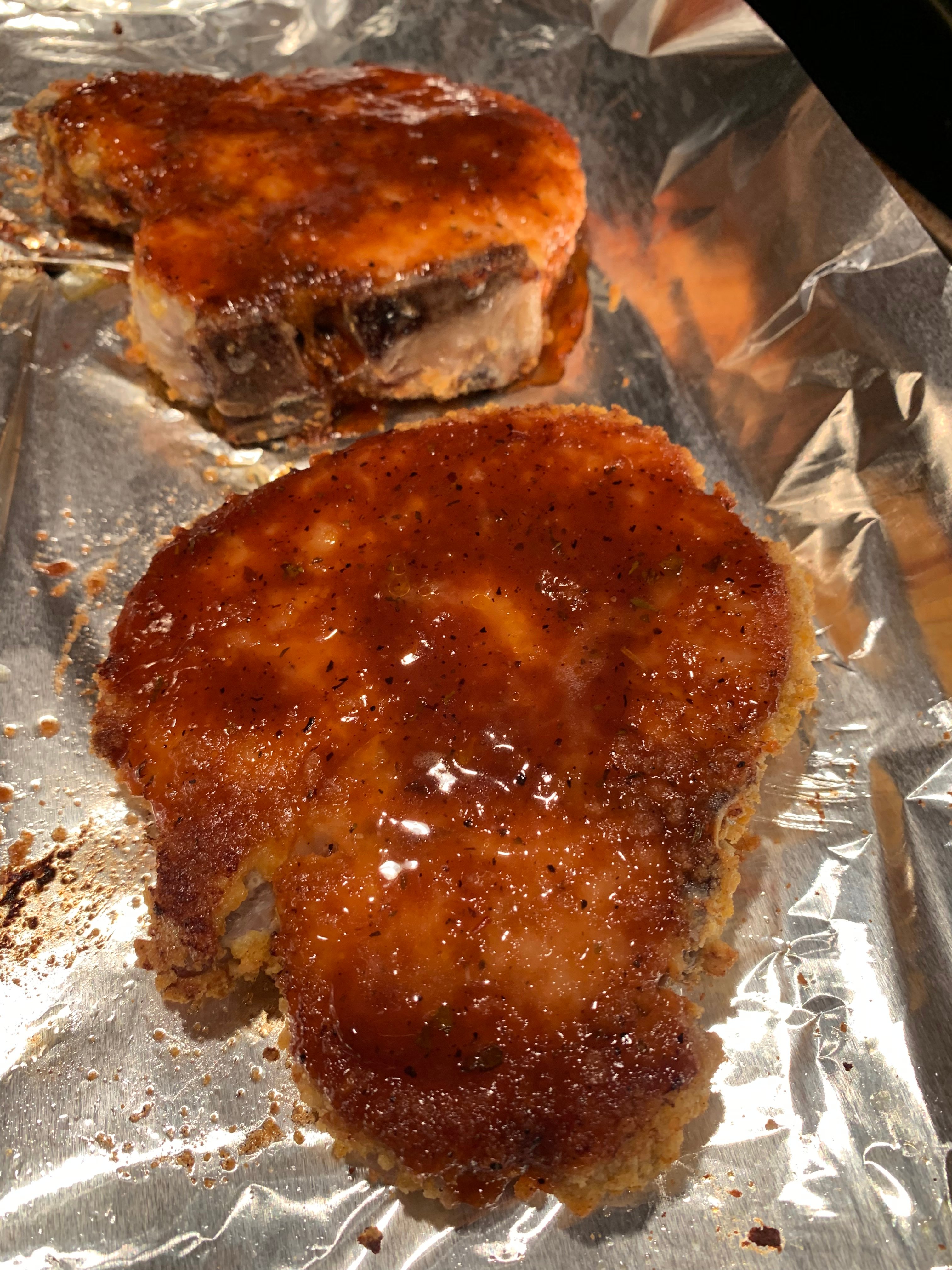 Picture of two crispy pork chops with BBQ sauce