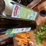 A bottle of white wine vinegar and a bottle of olive oil