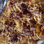 BBQ chips covered in shredded cheese and bacon before being backed