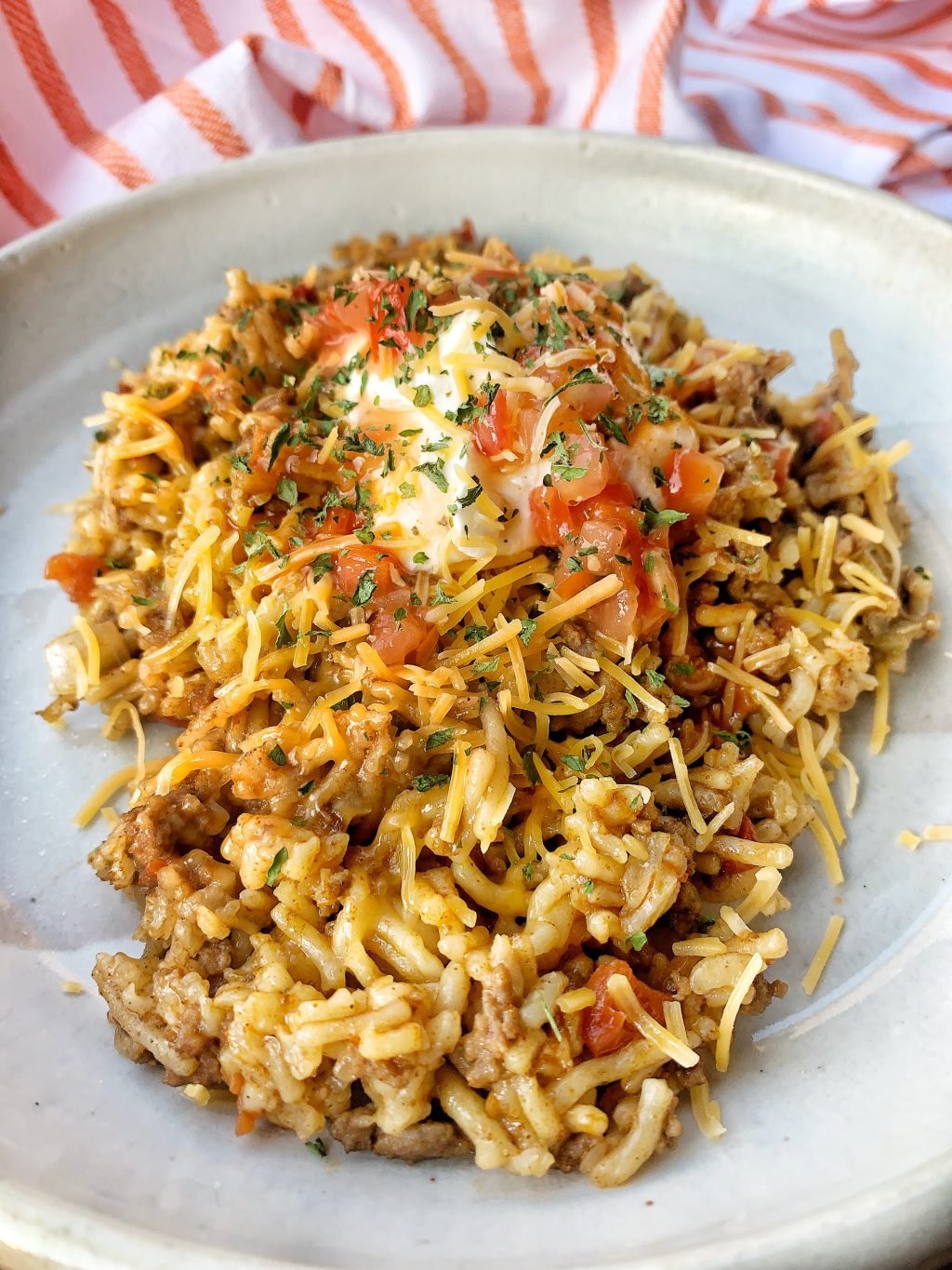 Instant Pot cooked taco rice using ground beef, taco seasoning, tomatoes and beef rice mix.
