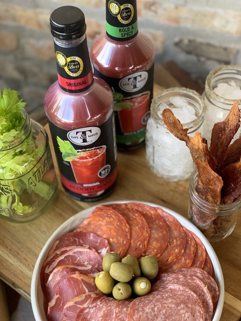 The components of the Bloody Mary Bar, including Bloody Mary Mix, bacon, salami, and olives
