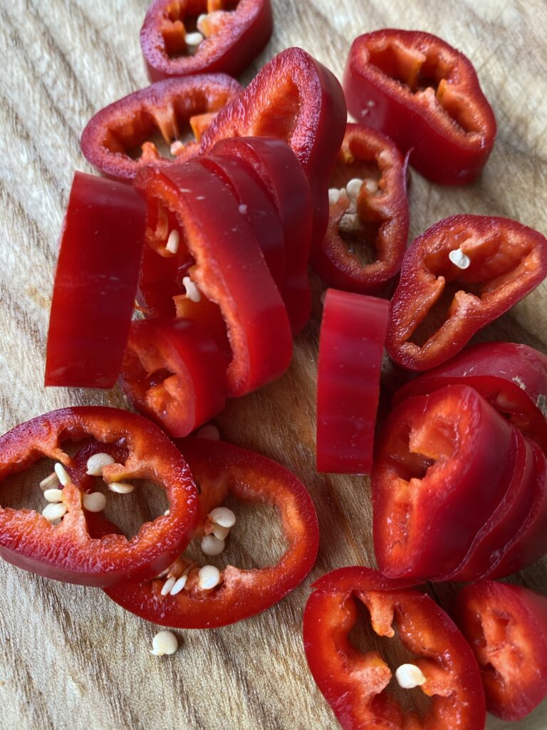 Sliced red Fresno peppers