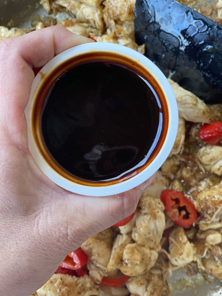 A small cup of dark sauce