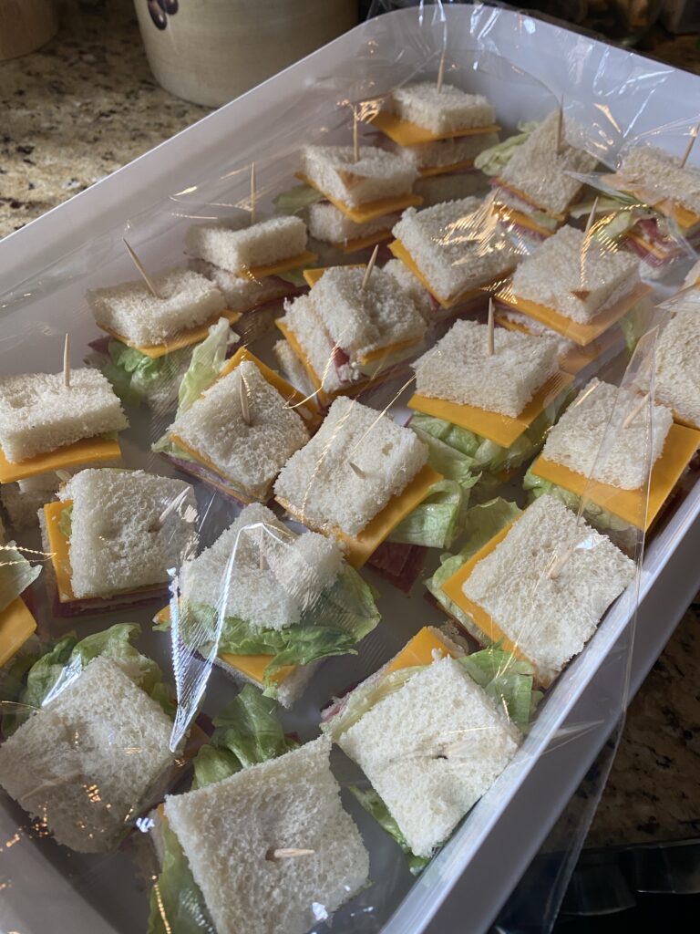 A platter of Salami and Cheese Beach Snacks with tooth picks under plastic wrap