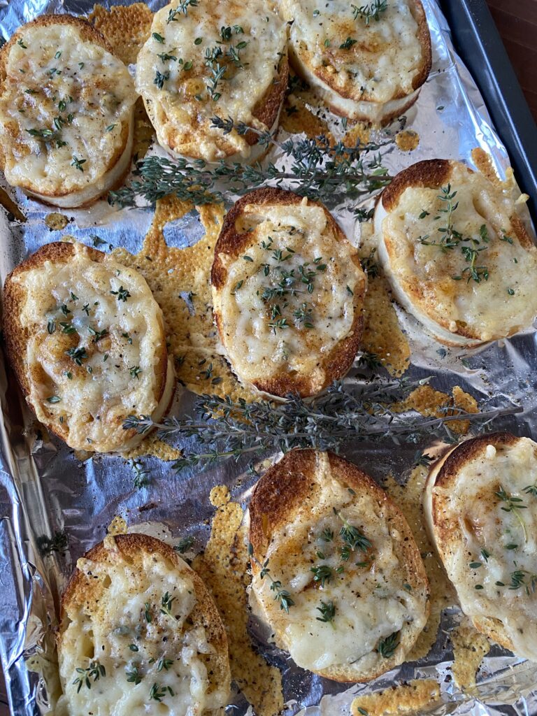A baking sheet with cheesy toasted bread dumplings