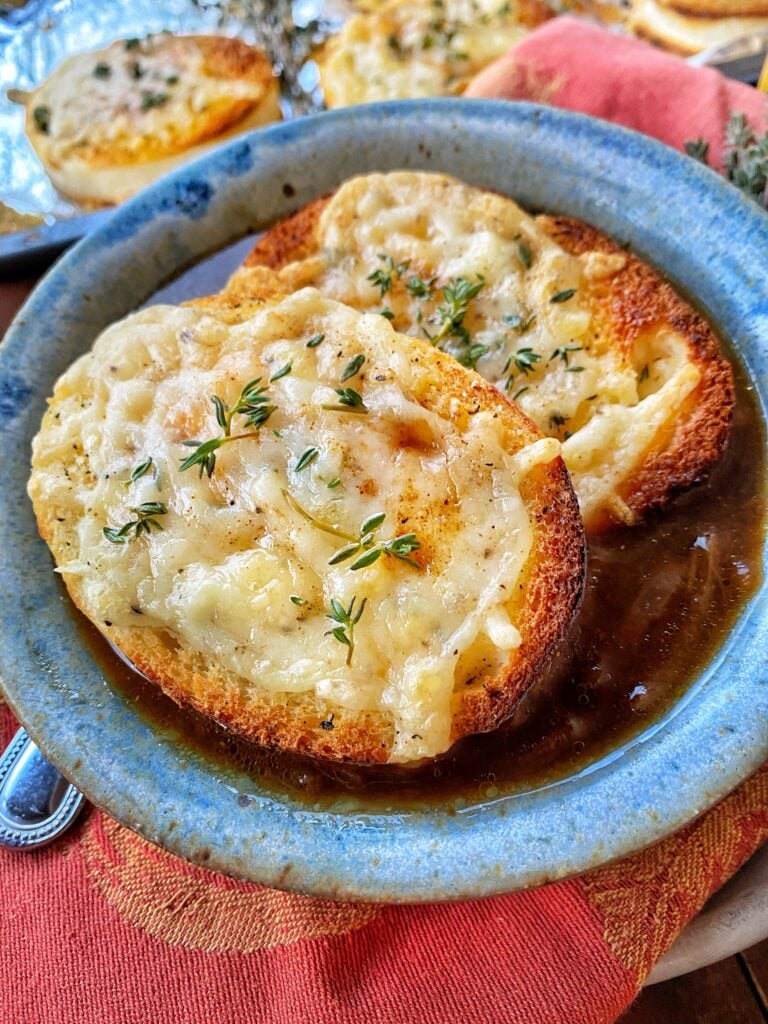 A bowl of French Onion Soup with Cheesy toast bread rounds