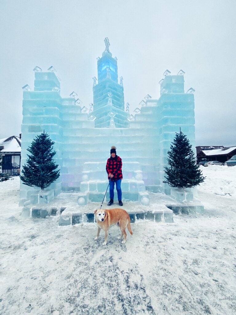 My mom with one of our dogs, Bailey, in front of an ice castle