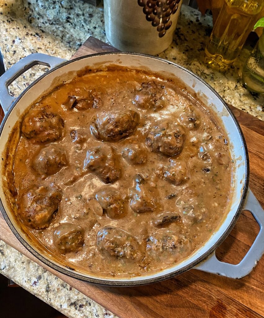A pot of Salisbury Steak meatballs in creamy gravy