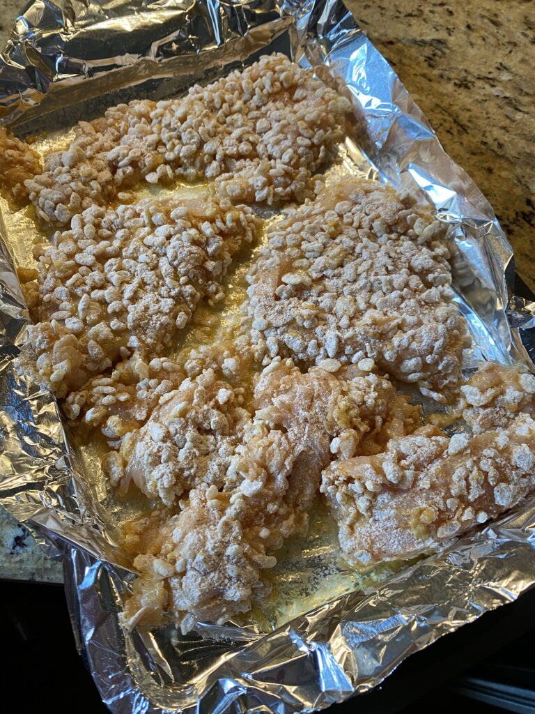 Pieces of chicken coated in the Rice Crispies mixture