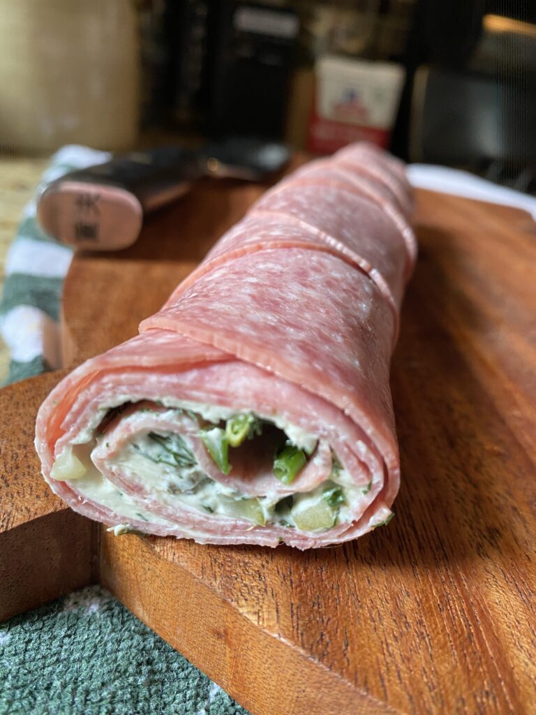 The rolled up salami viewed from the side so the fillings can be seen