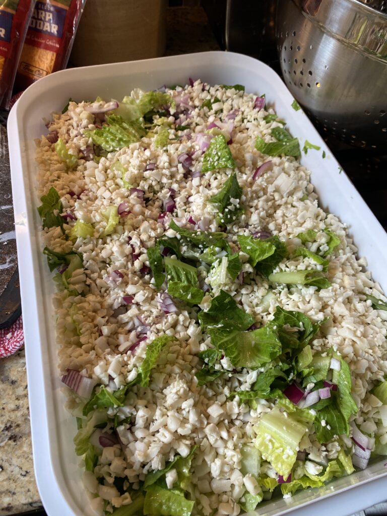 Chopped up cauliflower, greens, and onion