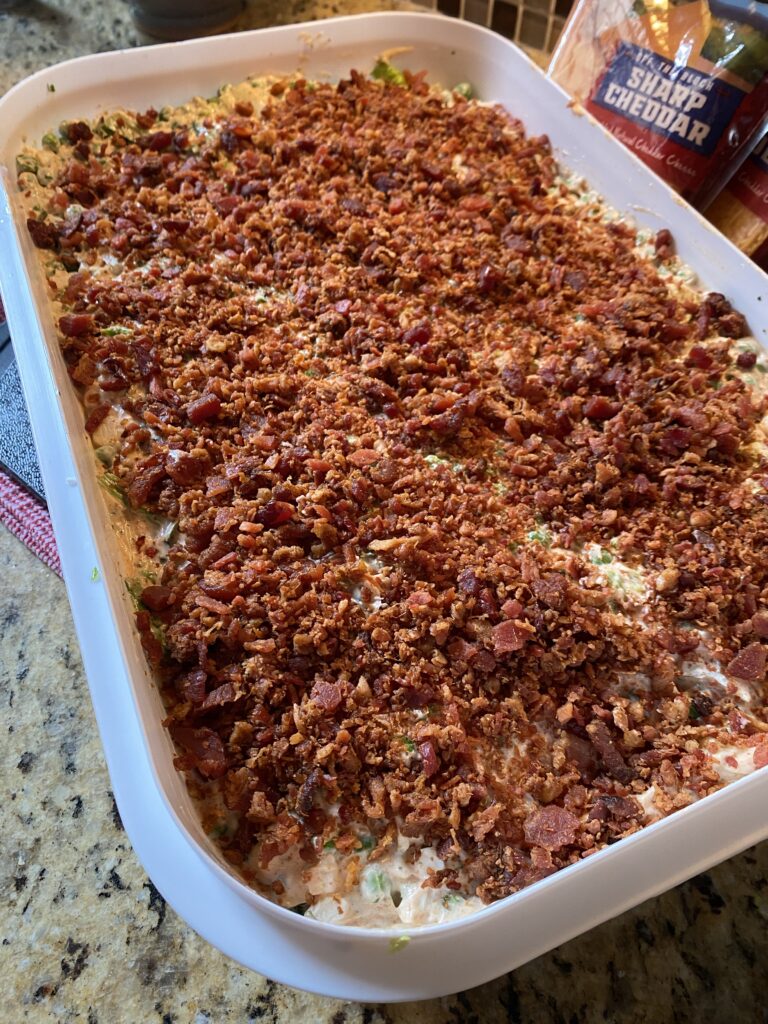 The seven layer salad topped with bacon