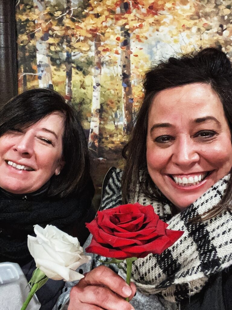 My mom and me holding flowers