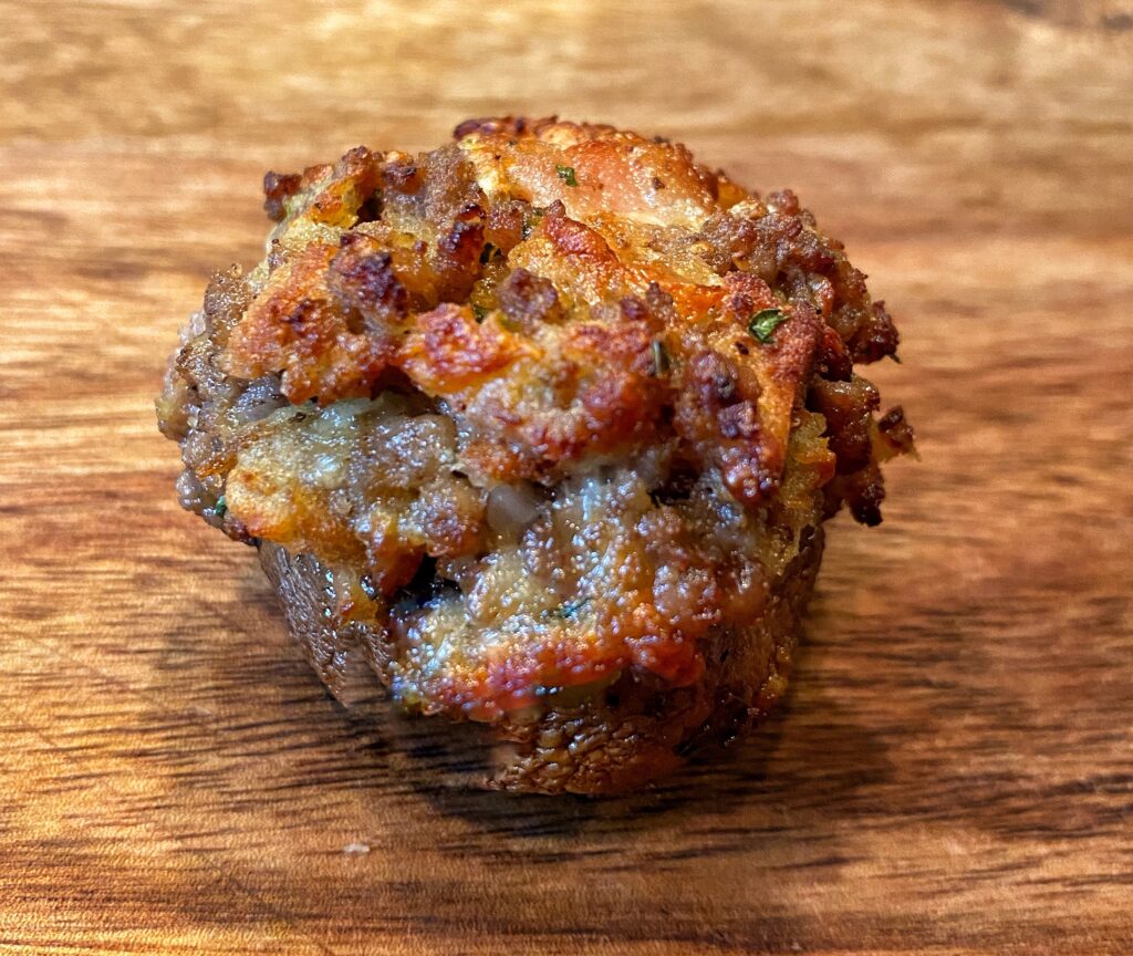 A close up of a bacon cheeseburger stuffed mushroom