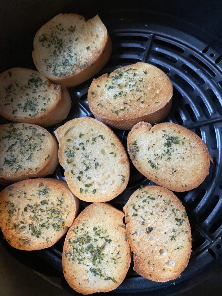 Pieces of garlic bread in an air fryer
