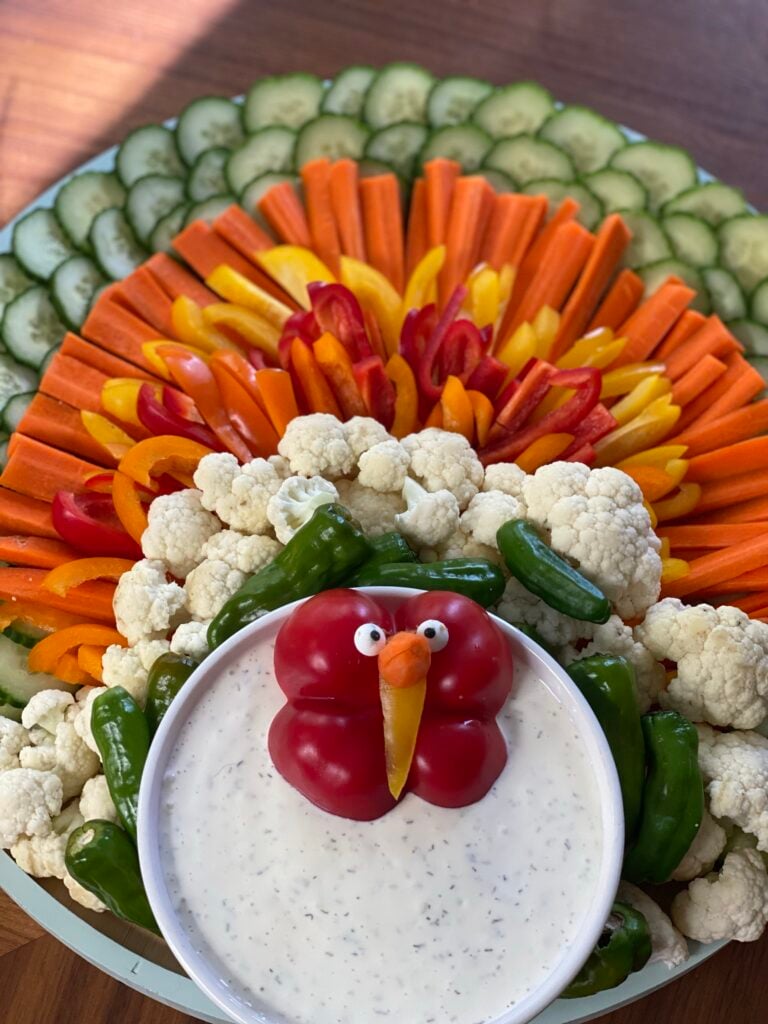 A veggie platter shaped like a turkey with ranch dip