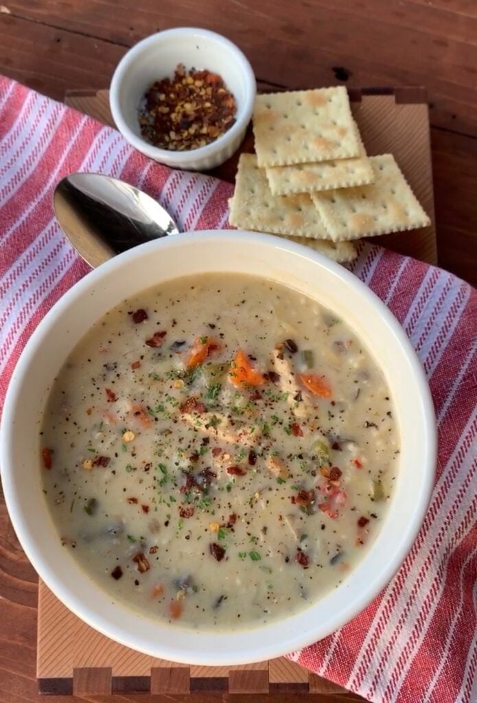 Creamy chicken and wild rice soup with Saltine crackers